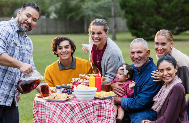 istock Multi-generation Hispanic family having backyard cookout 1142113290