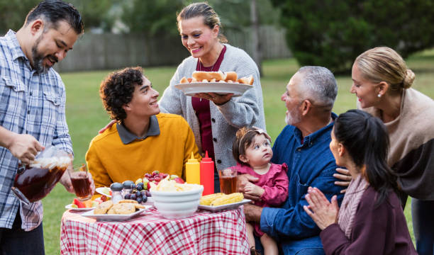 istock Multi-generation Hispanic family having backyard cookout 1142113292