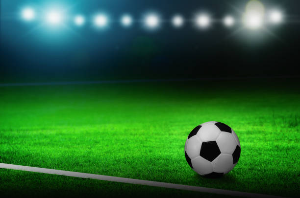 istock Soccer ball on green stadium 1142114167