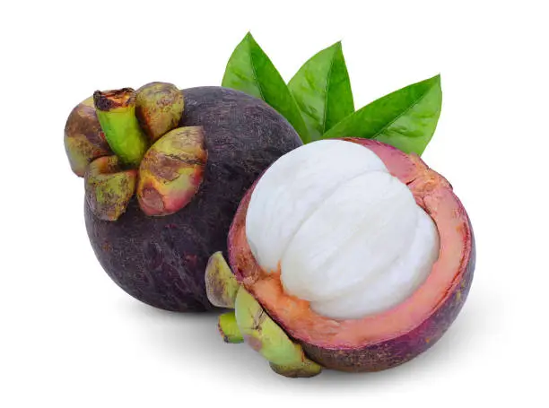 whole and half mangosteen with leaves isolated on white background