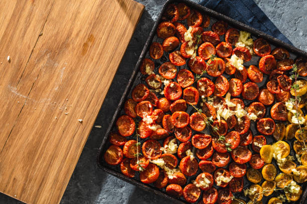 istock Baked juicy cherry tomatoes baking tray copy space top view 1142123098