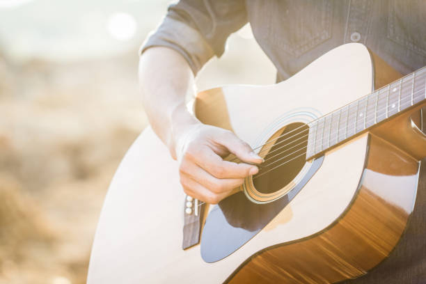 istock Playing on acoustic guitar outdoor 1142128668