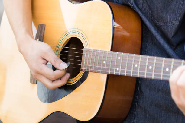 istock Playing on acoustic guitar outdoor 1142128709