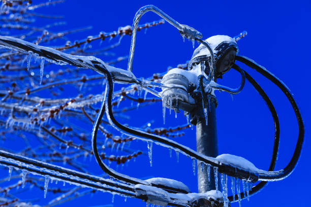istock Electrical box installation with crystal icicles hanging from the wires. Weather winter disaster in North America. Ice catastrophe in the cold Canadian spring. 1142130255