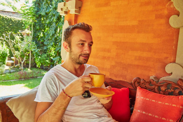 istock Man drinking coffee on a home porch. 1142137597
