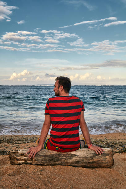 istock Man enjoying on a deserted tropical beach. 1142137654