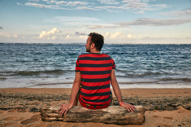 istock Man enjoying on a deserted tropical beach. 1142137717