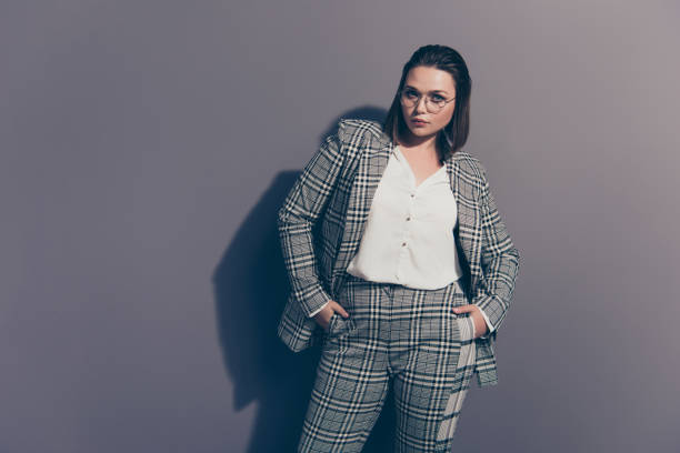 istock Portrait of her she nice cool representative beautiful attractive classy confident lady shark wearing checked blazer posing holding hands in pockets isolated over gray violet background 1142139934