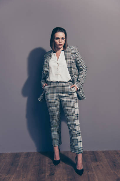 istock Vertical full length body size view portrait of nice cool representative beautiful candid lady shark wearing checked eyewear uniform holding hands in pockets isolated over gray background 1142140147
