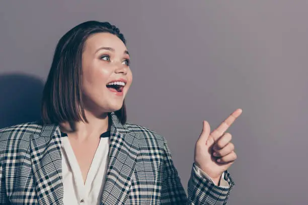 Sale discount position education concept. Close up photo portrait of cheerful funky chic funny in classic jacket office lady pointing on copy space isolated grey background.