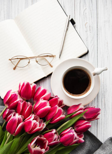 istock Notebook, cup of coffee  and pink tulips 1142142849