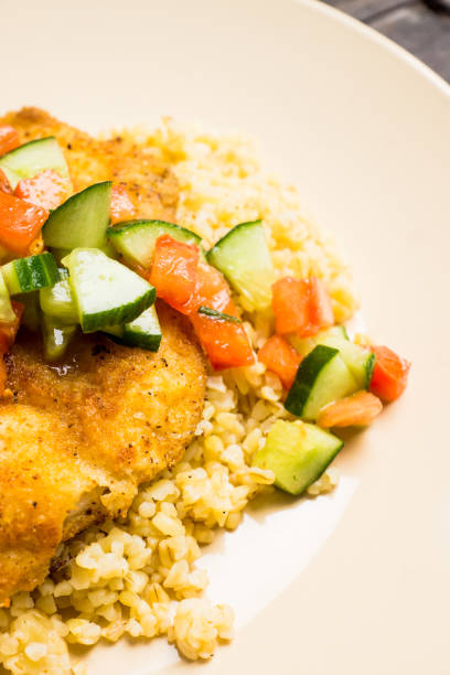 istock Prepared tilapia fish fillet served with salad 1142143033