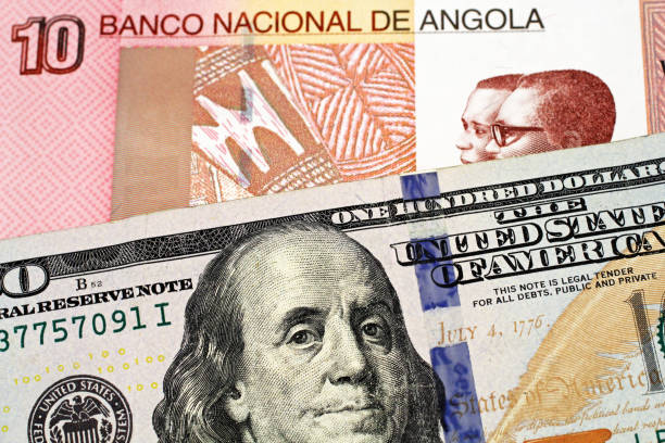 istock An Angolan kwanza bank note with an American one hundred dollar bill 1142144607
