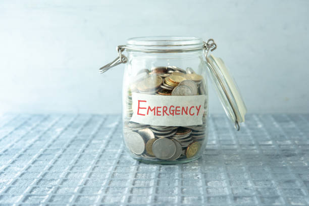 Money jar Coins in glass money jar with emergency label, financial concept. disaster stock pictures, royalty-free photos & images