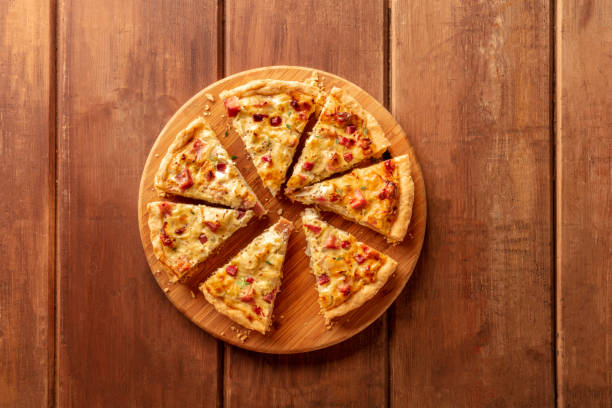 istock A quiche, shot from the top on a dark rustic wooden background with a place for text 1142149870