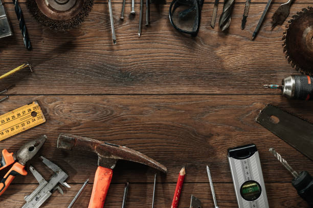 istock A construction tool on a brown wooden background. View from above. Picture background, screensaver. The concept of construction, repair, construction, production, design. Copy space. 1142152969