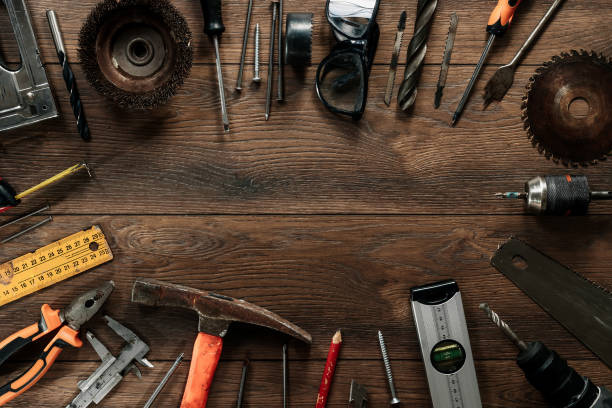istock A construction tool on a brown wooden background. View from above. Picture background, screensaver. The concept of construction, repair, construction, production, design. Copy space. 1142152972