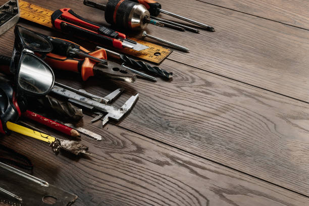 istock A construction tool on a brown wooden background. View from above. Picture background, screensaver. The concept of construction, repair, construction, production, design. Copy space. 1142152997
