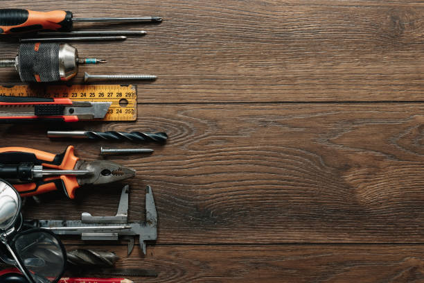 istock A construction tool on a brown wooden background. View from above. Picture background, screensaver. The concept of construction, repair, construction, production, design. Copy space. 1142152998