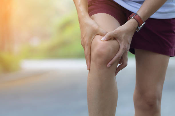 istock Asian woman use hands hold on her knee injury while running. 1142153230