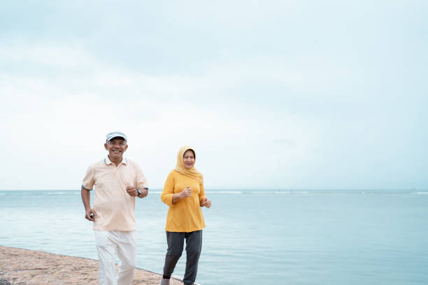 istock muslim old couple workout and running at the beach 1142153973