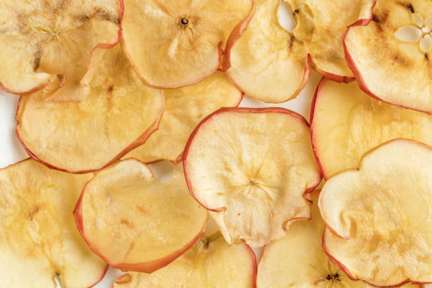 istock Close-up natural dried apple chips on white plate as background. 1142154047