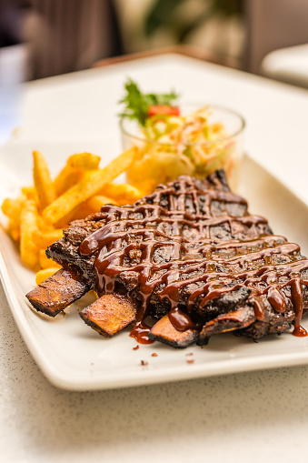 Iberico BBQ Ribs Signature melt-in-your-mouth and off-the-bone Spanish Pata Negra ribs served with cajun fries & coleslaw.