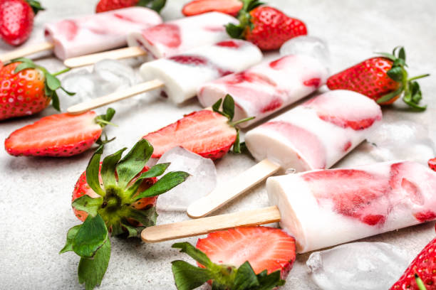 istock Fruit popsicle with frozen strawberry and yogurt, ice cream on stick 1142159979