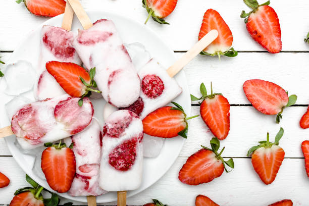 istock Fresh strawberry popsicles with yogurt and strawberries. Ice pops, flat lay, top view 1142160067