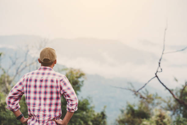 istock Hiking man traveling with backpack in mountains 1142166017