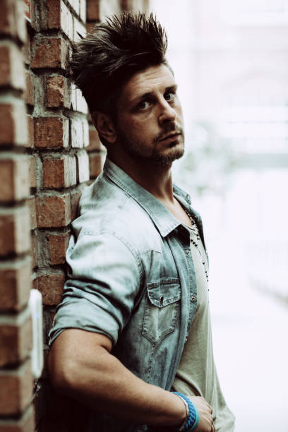 istock Portrait Of Handsome Man Standing By Building Wall 1142166377