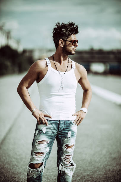 istock Handsome Man With Hands On Hip Standing On Road 1142167287