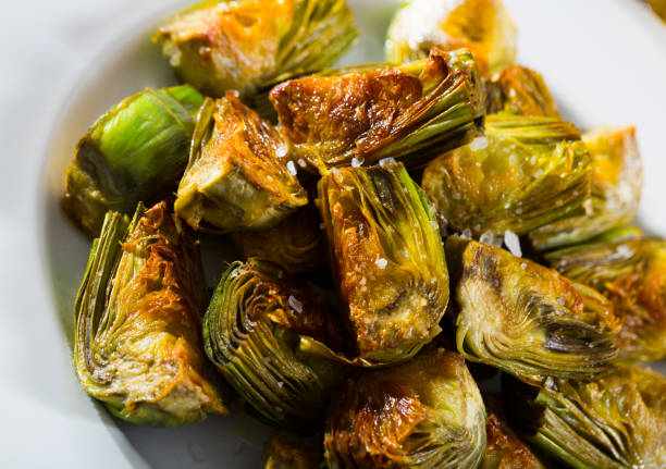 istock Delicious fried artichoke halves on a white plate 1142167535