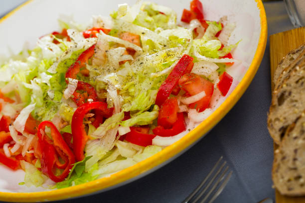istock Summer vegetable salad - red bell peppers, lettuce and onions 1142169151
