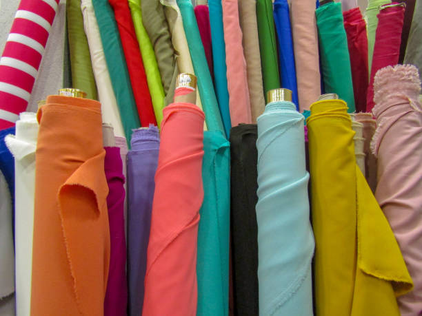 Rolls of fabric. Rolls of fabric of different colours in a sewing workshop. fabric shop stock pictures, royalty-free photos & images