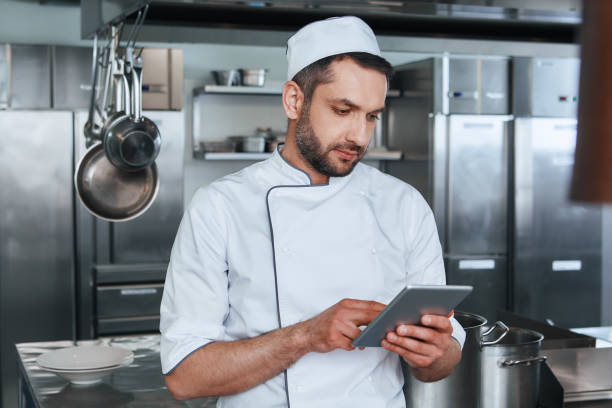 istock Ready to do his best. Chef cook is looking for recipes 1142169914