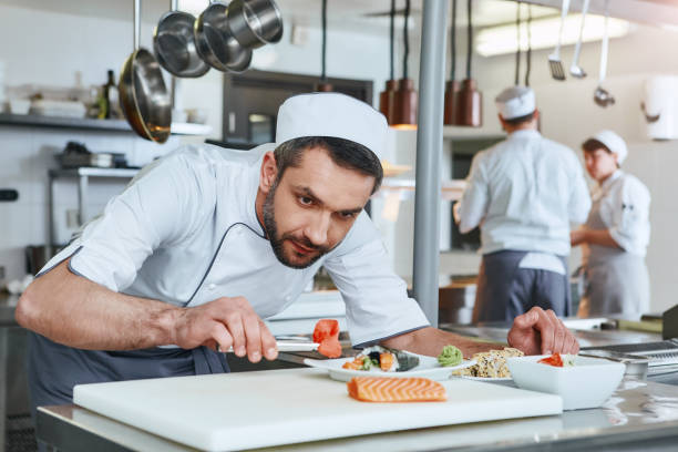 istock We know how to cook. Chef cook preparing japanese food in modern commerical kitchen 1142169984