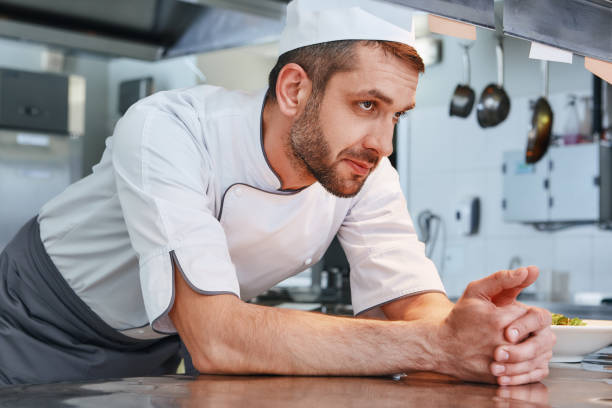 istock We know our food. Male chef leaning on the table and looking aside while going to cook 1142170105