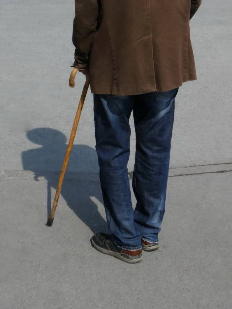 istock Senior man walking with help of a walking stick 1142170210