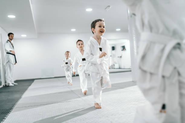 istock Small group of children having training at taekwondo class. All dressed in doboks. White background. 1142170805