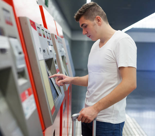 istock Man using terminal for buying ticket on subway 1142170869