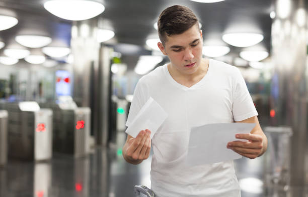 istock Man holding papers in underground station 1142170921