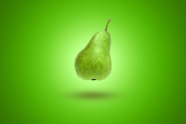 istock Green pear on a green background. Artistic background. 1142172203