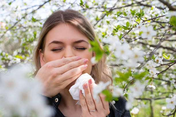 istock Allergic woman sneezing outdoor on springtime 1142177267