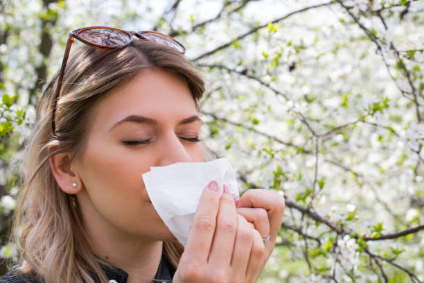 istock Allergic woman sneezing outdoor on springtime 1142177816