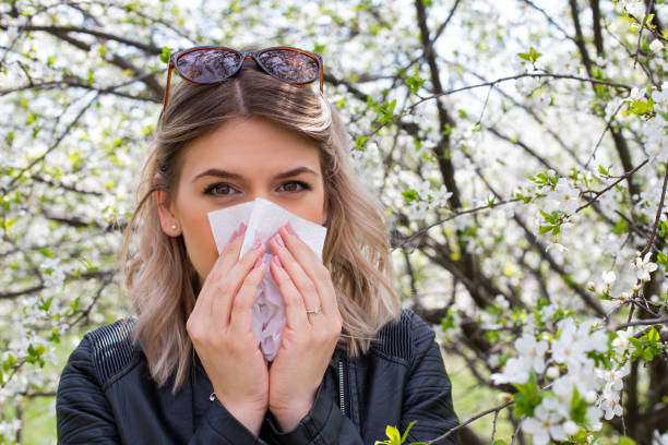 istock Allergic woman sneezing outdoor on springtime 1142178206