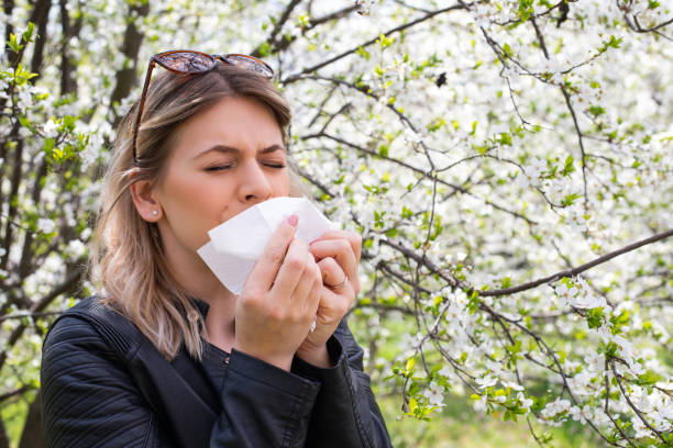 istock Allergic woman sneezing outdoor on springtime 1142178304