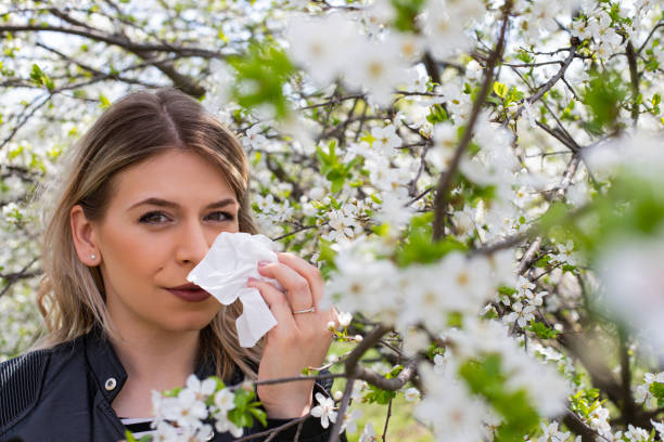 istock Allergic woman sneezing outdoor on springtime 1142178644