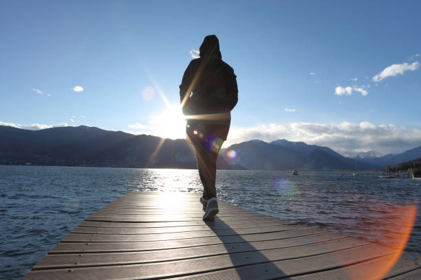 istock Woman walks along curving dock 1142179619