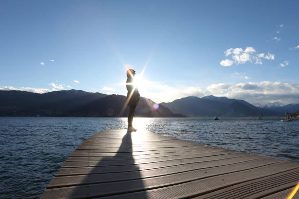 istock Woman looks out while standing on dock 1142179685